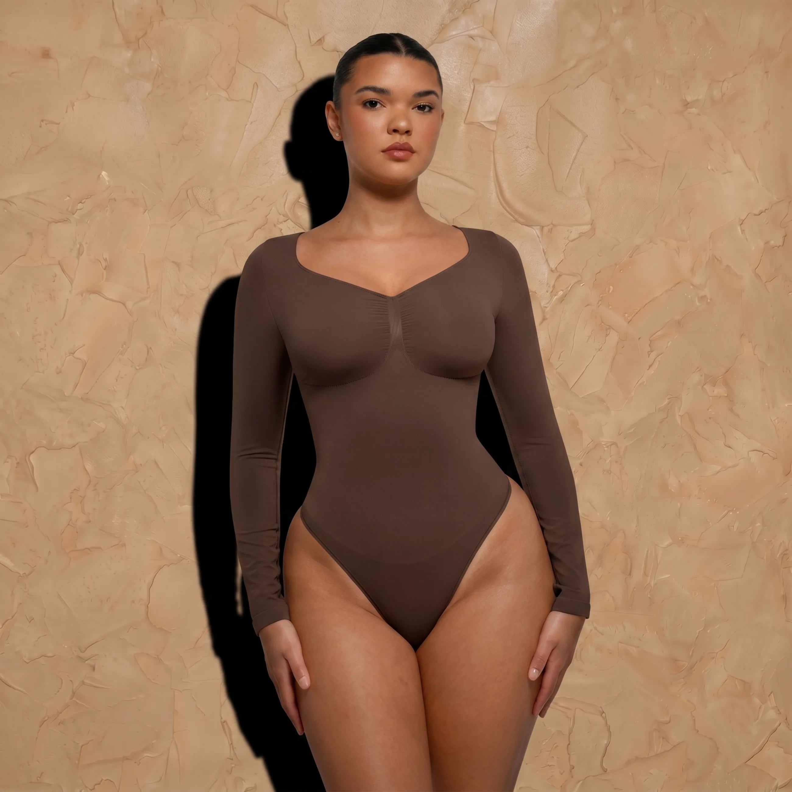 Vellure Paris Signature L'Amour — Sophisticated long-sleeve sculpting bodysuit featuring an elegant diamond neckline and a seamless thong silhouette for all-day comfort.