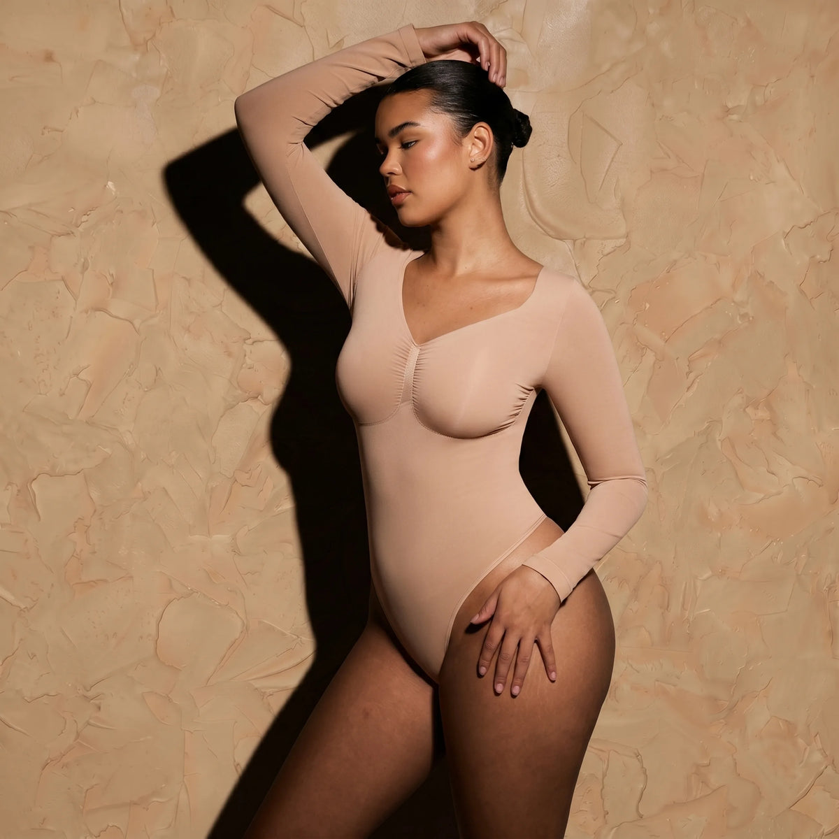 Vellure Paris Signature L'Amour — Sophisticated long-sleeve sculpting bodysuit featuring an elegant diamond neckline and a seamless thong silhouette for all-day comfort.