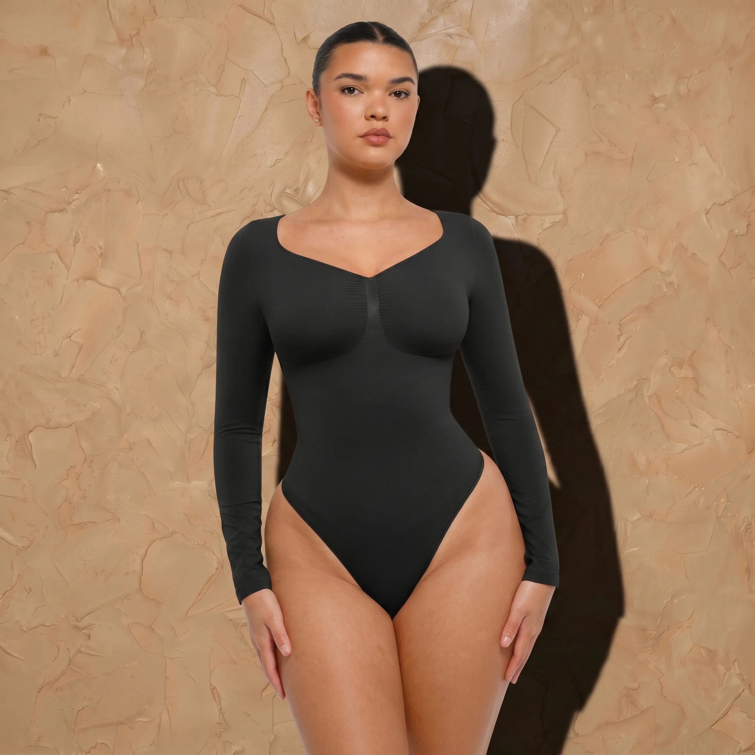 Vellure Paris Signature L'Amour — Sophisticated long-sleeve sculpting bodysuit featuring an elegant diamond neckline and a seamless thong silhouette for all-day comfort.